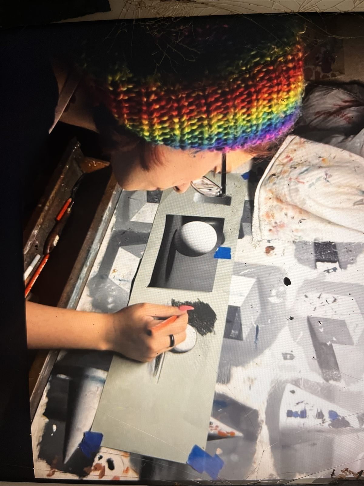The artist shading a still-life drawing with a pastel pencil